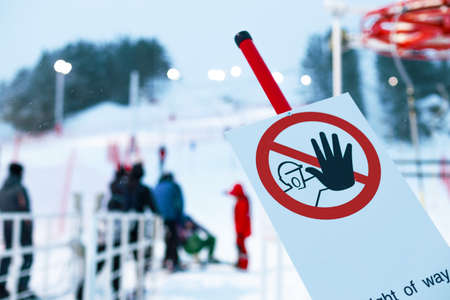 in the foreground there is a sign do not touch with hands, the background is blurred people on the...