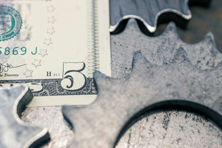 gears and dollars, money and mechanisms. economy in actionの写真素材
