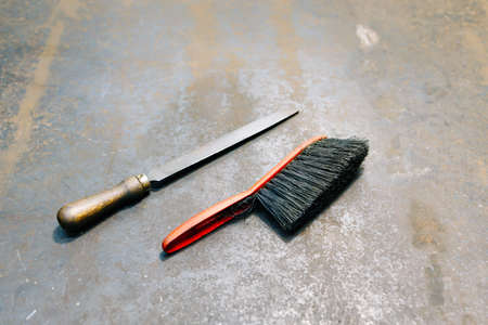 old tools in the lathe, an old file and an old brush for cleaning the workbench