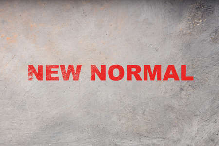the new norm is written in red letters on a gray background. the concept of a new reality in life in...