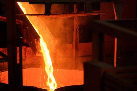 molten metal from the furnace is poured down the chute into the vat. spraying hot metal first stage...