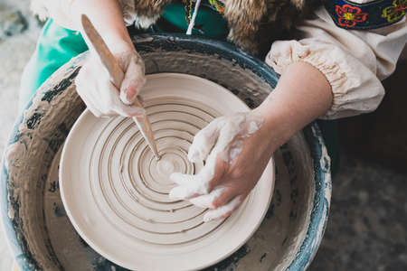 top view of the potter's hands and the process of his work. creating a plate in the old wayの写真素材