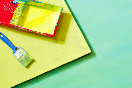 on the painted surface there is a container for paint and a brush. preparation of photos made of...