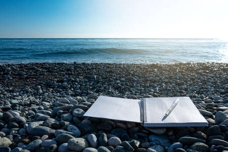 notebook by the sea and and a fountain pen. open for entries. keep records by the sea. holiday inspirationの写真素材