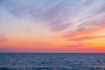 the sky with feathery clouds, beautiful clouds in the sky. sunset on the seashoreの写真素材