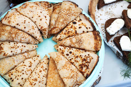 plate with pancakes rolled into triangular envelopes. homemade homemade foodの写真素材