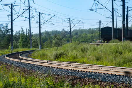 turn of the railway road in the forest, outgoing freight train. landscape with trainの写真素材