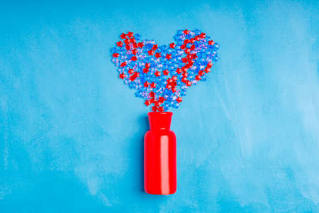 The vases are filled with red and blue stars and create a heart shape. a gift to a loved oneの写真素材