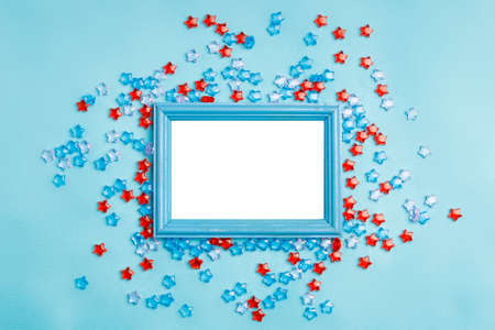 blue wooden frame made of wood on a blue background around a plastic star frame. mockup frame for your photos, to insert a photo or textの写真素材