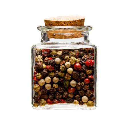 peppercorns in a glass square jar on a white background. spice storageの写真素材