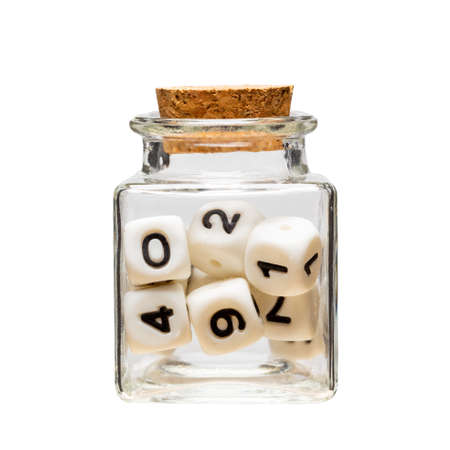 inside a glass square jar there are cubes with numbers. numbers inside closed containerの写真素材