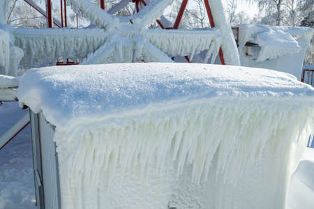 air-conditioned container outdoors covered with ice and snow. icing on the outside of the air conditionerの写真素材