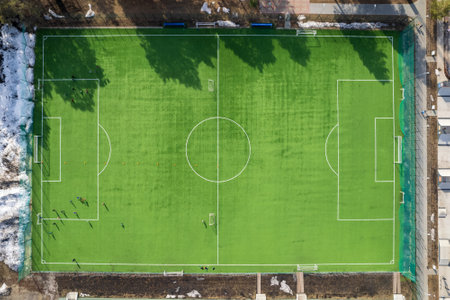 green football field with artificial turf from above. drone view of the sports ground