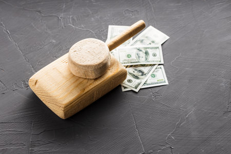 top view of a wooden toy tank that rides on money. war and money are always thereの写真素材