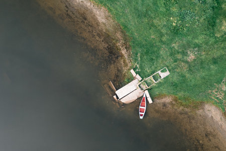 aerial view of a boat on the water, an old pier and a fishing boat. drone photographyの写真素材