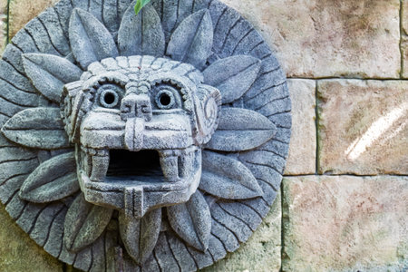 animal head made of stone on the wall in the style of South American Indians. imitation of historyの写真素材