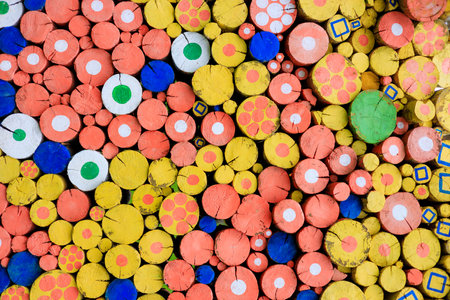 the logs are stacked, the saw cuts of the logs are painted with paint. different paints and wooden logsの写真素材