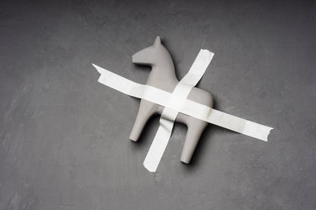 a gray horse is taped to a gray wall. fixed creatureの写真素材