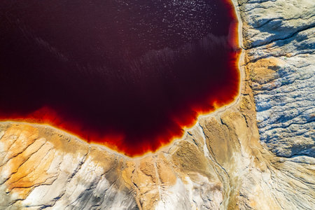 drone view of an alien landscape with a red lake. landscape similar to space to another planet. red sand quarryの写真素材