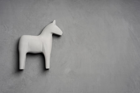 wooden gray toy horse on a gray background. gray on grayの写真素材
