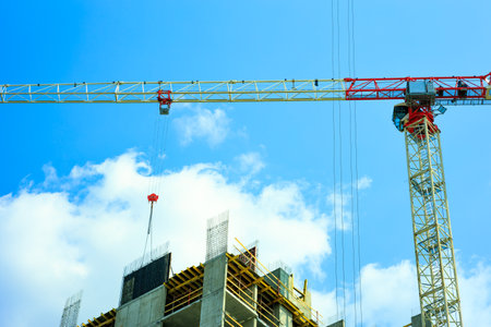 tower crane on the background of a construction site, work on a construction siteの写真素材