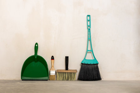 dustpan brush and metal for cleaning the room against the wall. tools after constructionの写真素材