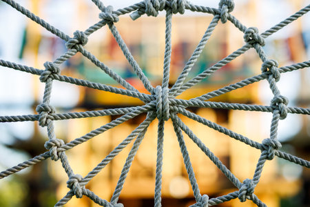 A close up of a web of ropes with a yellow backgroundの写真素材