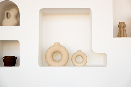 A white shelf with a few vases on it.の写真素材