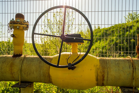 The valve wheel on the gas pipe is used to close the gas flow. yellow gas pipeの写真素材