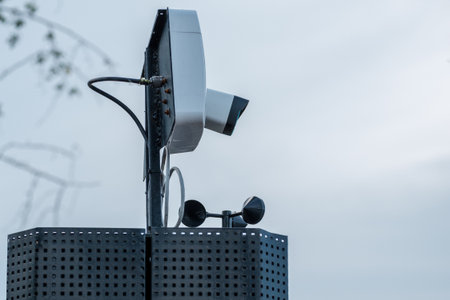 A security camera is installed on the pole. background sky summer day