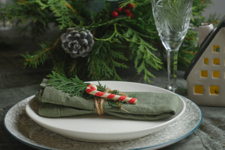 Christmas table setting. Festive dinnerware on table.の写真素材