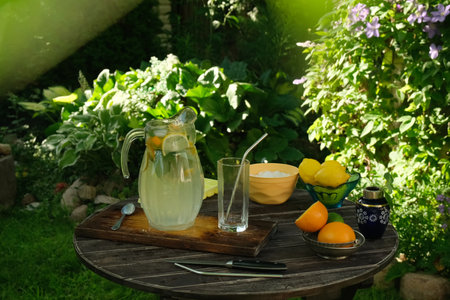 Ingredients for making lemonade on garden wooden table.の写真素材