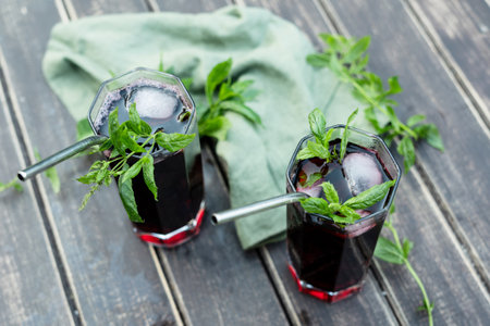 Summer cocktails. Two drinking glasses with red cold hibiscus tea and mint.の写真素材