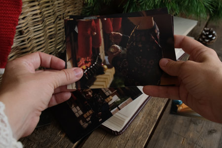 Hands Holding Printed Christmas Photosの写真素材