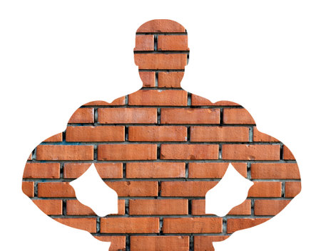Muscular bodybuilder silhouette isolated on background. Sport man strong arms. Body builder athlete showing muscles photo. Brick wall with muscular body pose exhibitionの写真素材