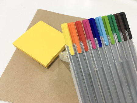 colorful magic pen with notebook ad post it use for summarizing and easily remember on white backgroundの写真素材