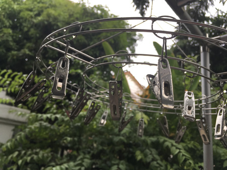 Clamp hang with droplet on clothes line in rainy dayの写真素材