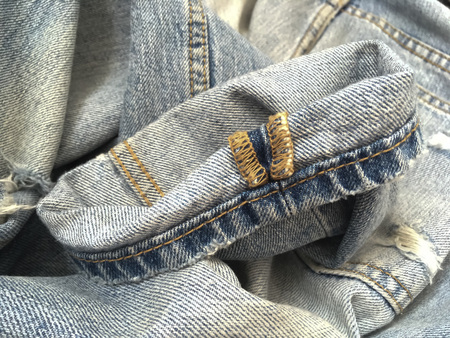 Pinroll cuff of rip old blue jeansの写真素材