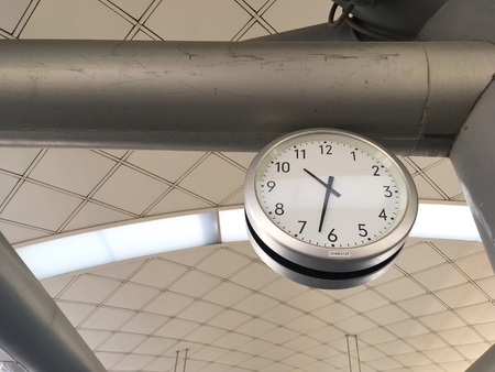 Clock hang on pillar of ceiling show the time at train stationの写真素材