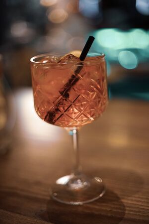 colorful cocktail with ice and a pipet insideの写真素材