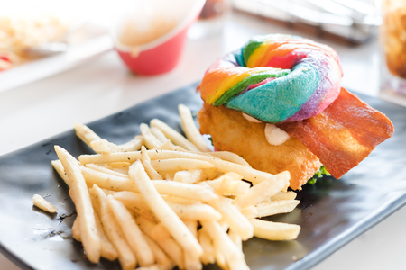 Rainbow Bagle with fish and friesの写真素材