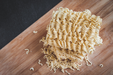 packs of instant noodle on wood backgroundの写真素材