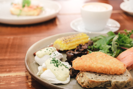 A breakfast platter with a cup of coffeeの写真素材