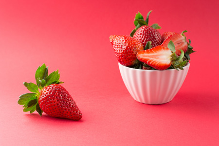 Juicy fresh strawberries on red background, selective focusの写真素材