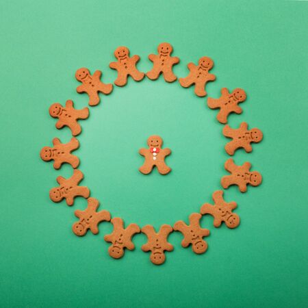 Frame made of homemade christmas gingerbread cookies green background with copy space for text....