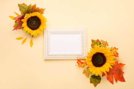 Autumn floral frame, web banner. Sunflowers, dried leaves, pumpkins, apples and rowan berries on...