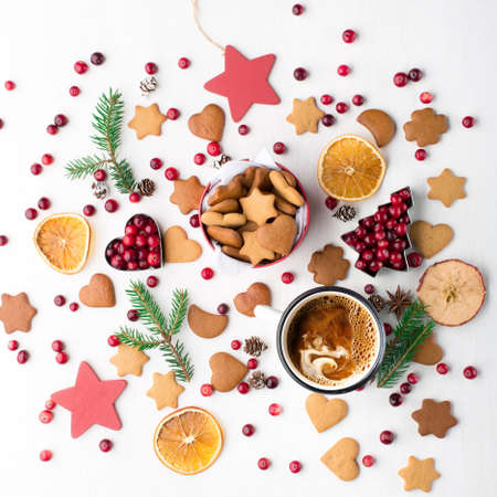 Rustic white wooden background with cup of hot coffee and gift of Christmas cookies. Seasonal...