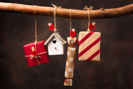 Christmas calendar with gifts for children. Textile advent calendar on dark wooden background....
