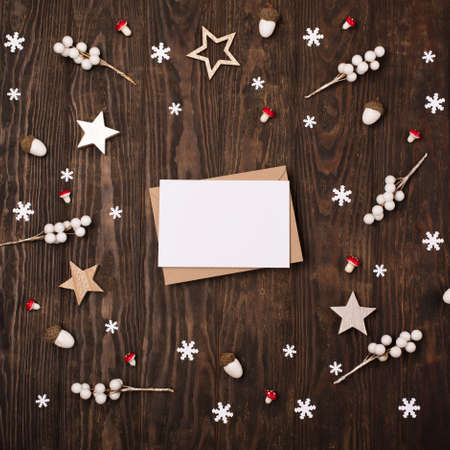 Christmas letter to Santa mockup with craft envelope. Festive dark wooden background. Flat lay, top view, copy space. Winter holiday concept.の写真素材