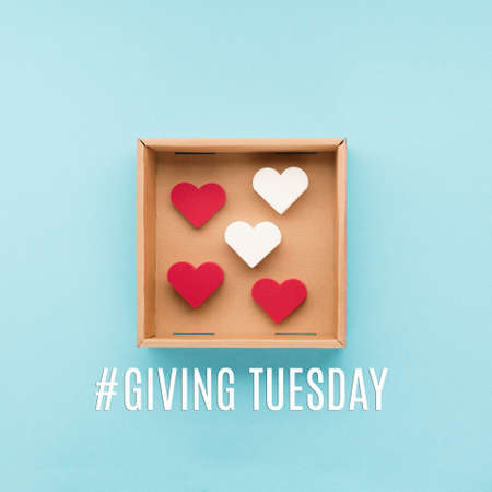 Giving Tuesday, global day of charitable giving after Black Friday shopping day. Charity, give help, donations support concept. Text message, gift box, red hearts on blue background.の写真素材